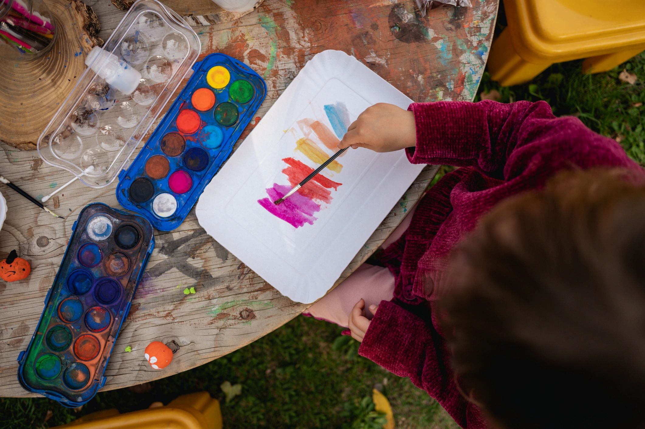 Child's hands drawing colorful artwork